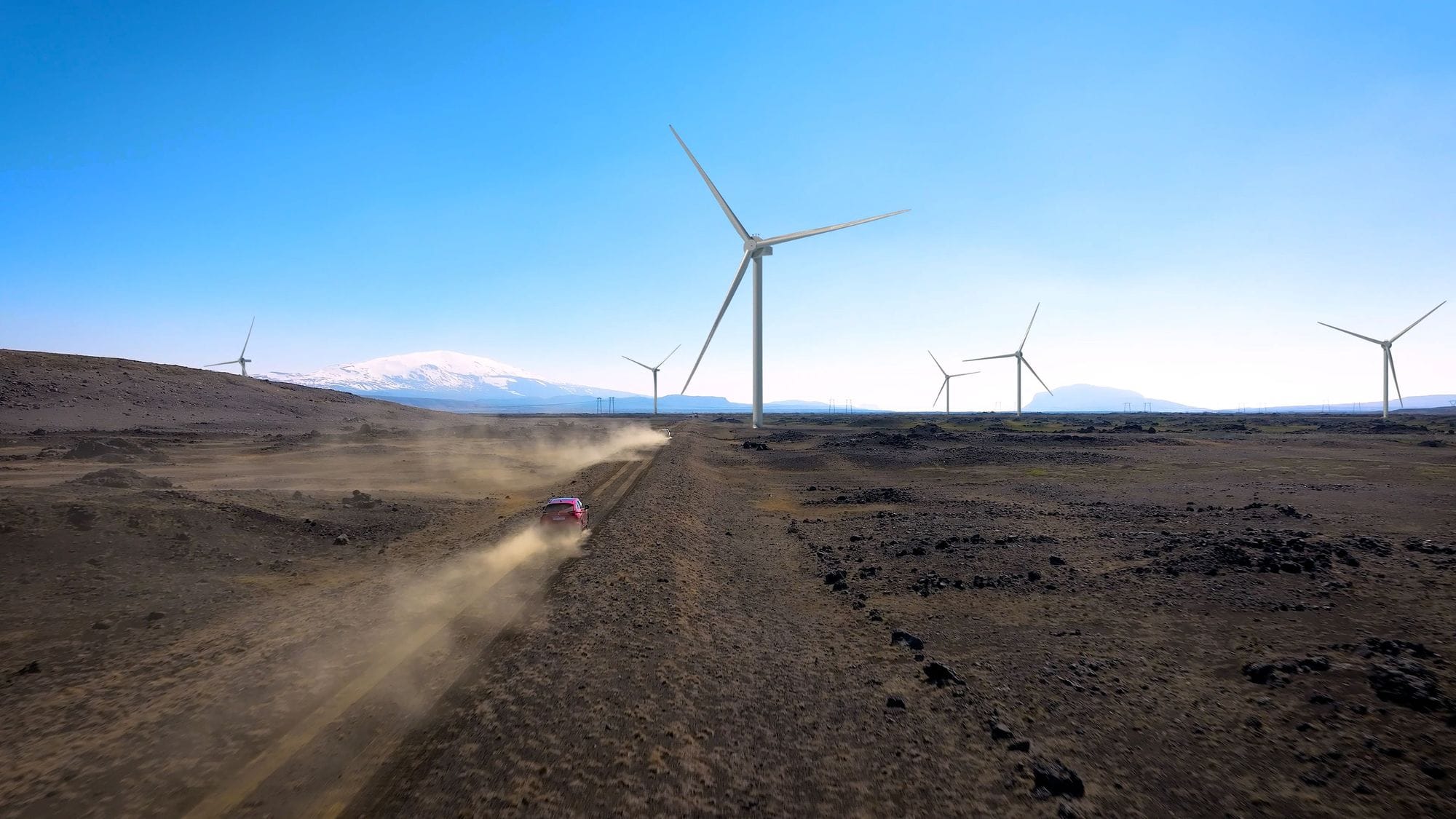 Tölvugerð mynd af vindmyllum og bíll á vegi.